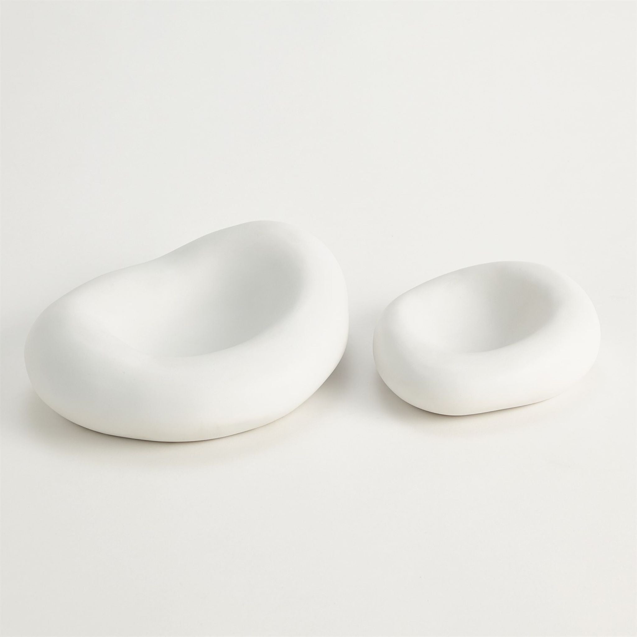 SIMPLY ELEVATED - Crafted in Italy, these organic shaped ceramic bowls have a matte white finish and available in two sizes.
