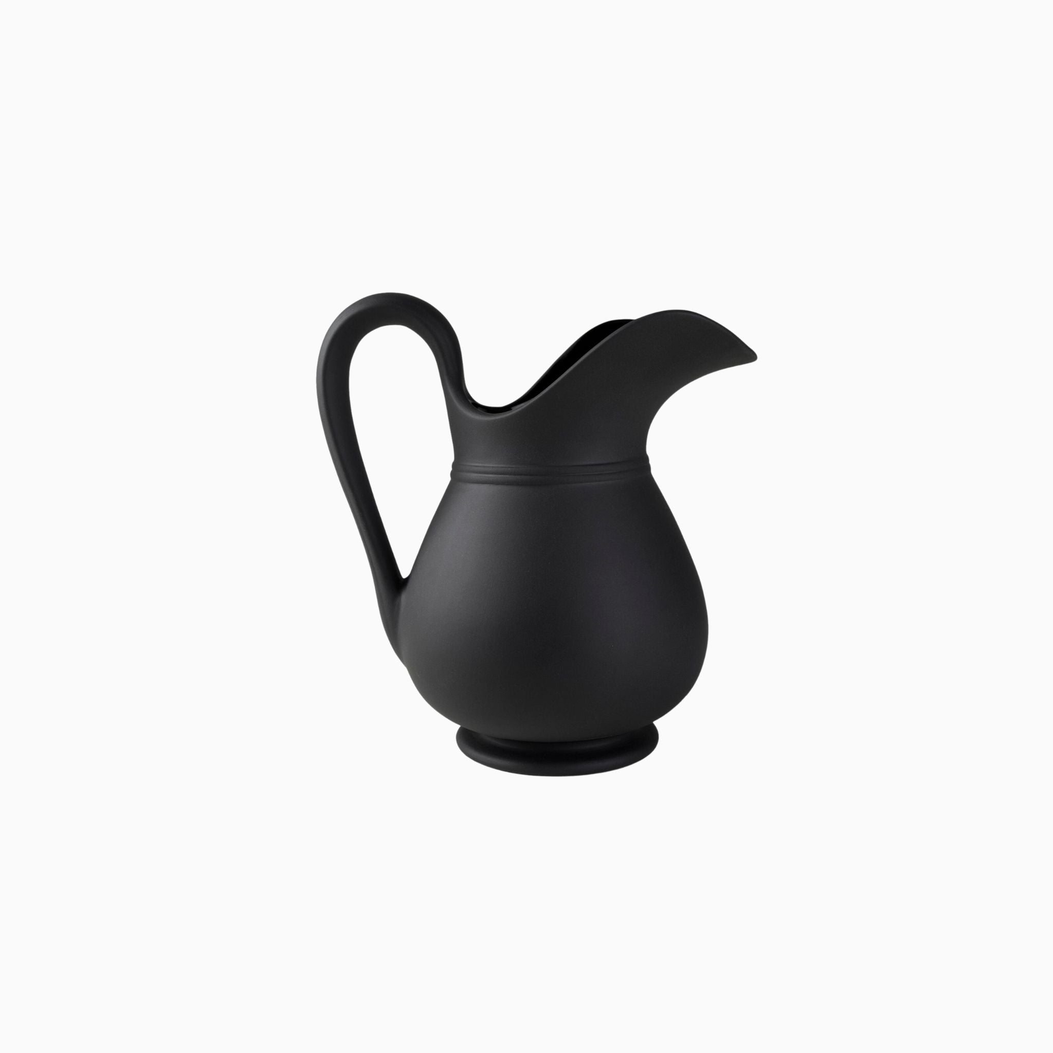 Simply Elevated - Stoneware pitcher meticulously carved by hand and then slip-cast in Sri Lanka. Available in a matte black terracotta with a shiny glazed interior. We love them for serving drinks, holding flowers, or standing proud on the mantel.