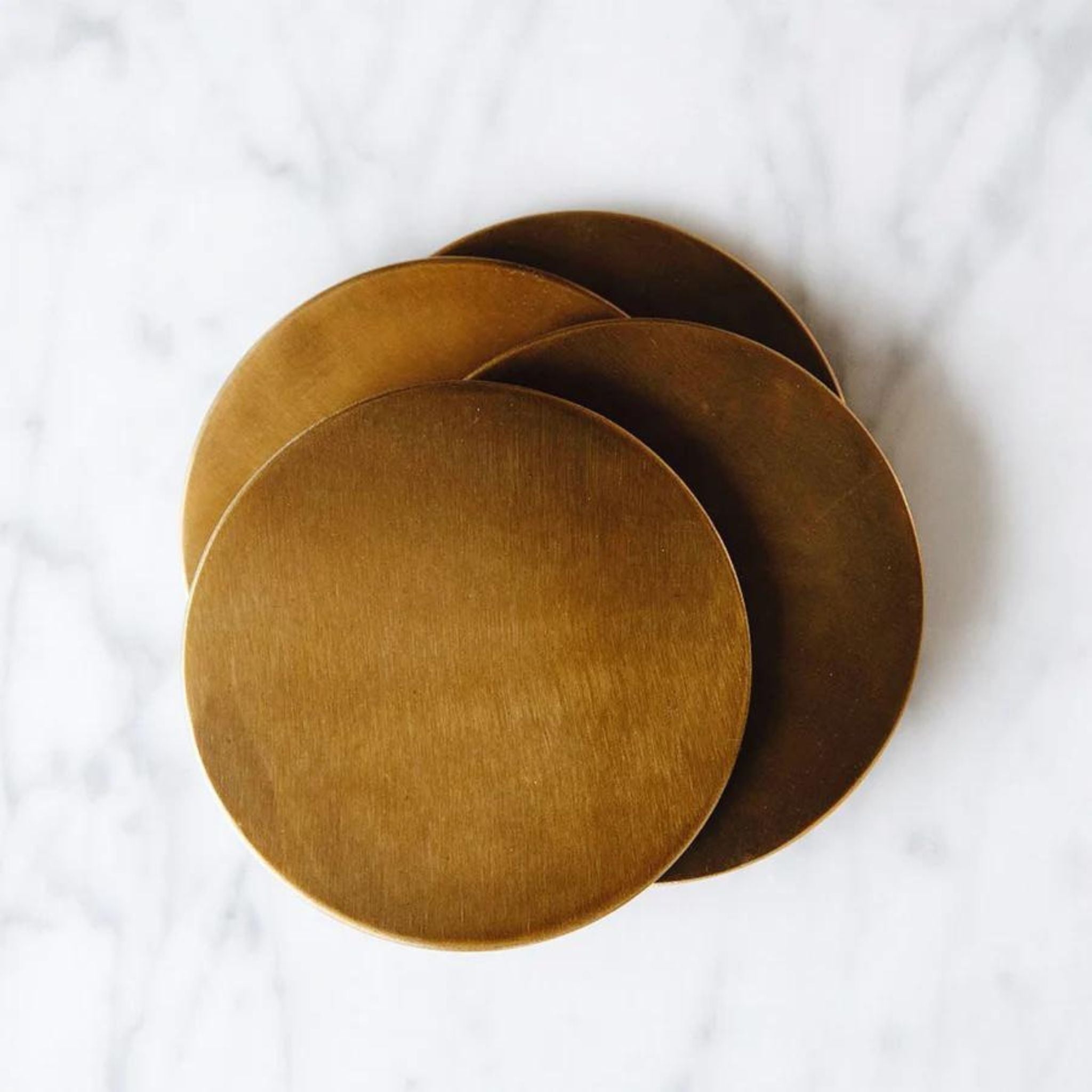 Simply Elevated - These coasters are fashioned using pure metals and alloys that will oxidize over time. They are sold in sets of four, and the graphically patinated disks will age gracefully as their lacquer fades to reveal the natural wear of their use. Available in solid brass, copper-plated brass, or nickel-plated brass, each piece is backed with natural cork to protect your delicate surfaces.