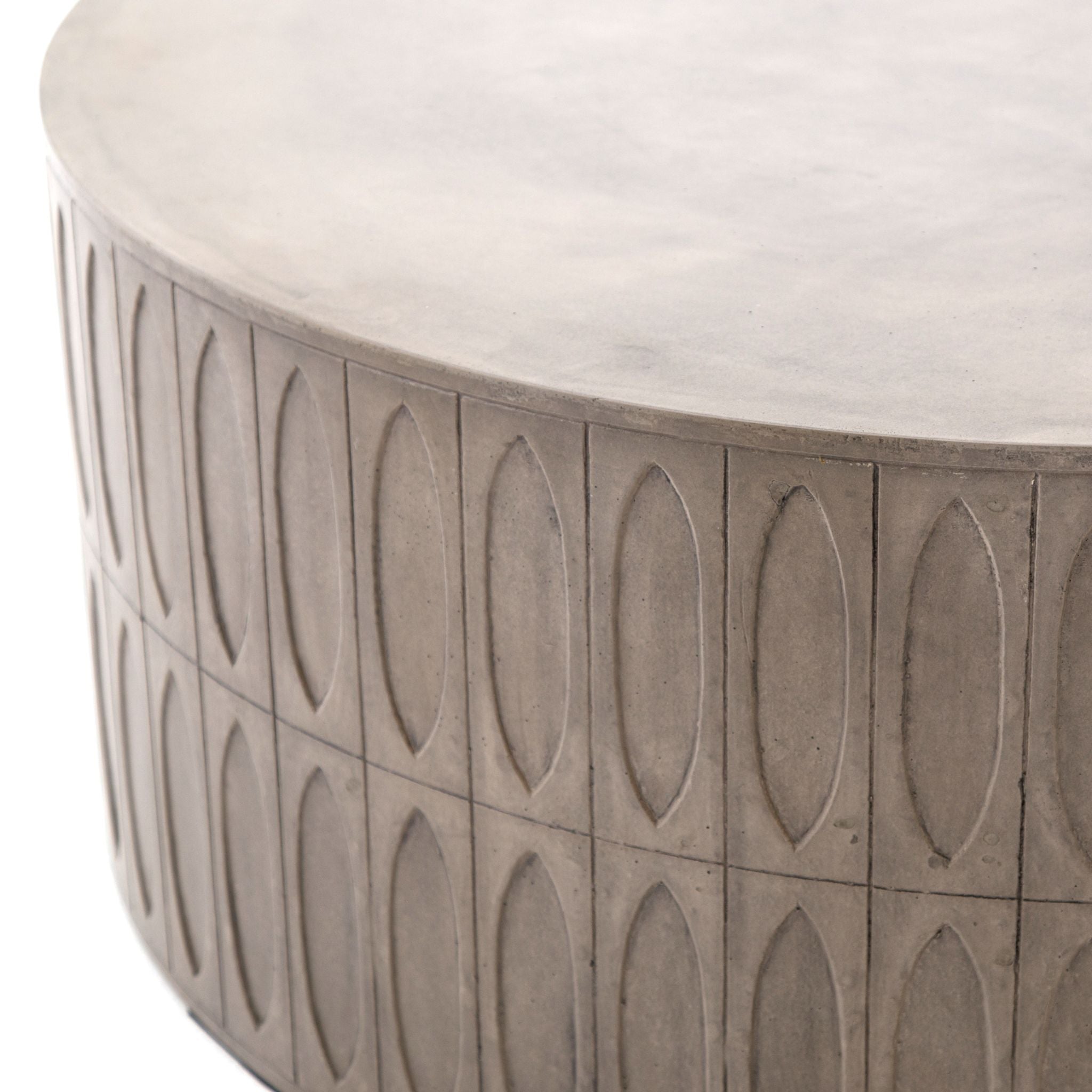Concrete adopts alluring shapes as modern geometrics play with nature's petal form. A hollowed drum of dark grey concrete is intricately etched for artistic intrigue. Safe indoors or out. Cover or store indoors during inclement weather or when not in use.
