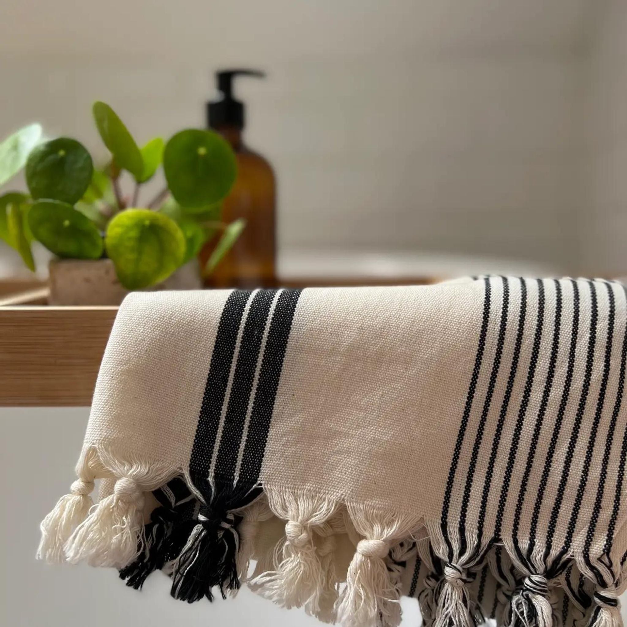 This lovely flat weave cotton towel is a super all-rounder in the home. Generously loomed with simple utility navy stripe details and a hand-finished fringe, the silas can be used as a hand, hair and tea towel, bath mat or even as a place setting at the table. Its packaging denotes multi-functional uses - perfect for those who like to do more with less.. 